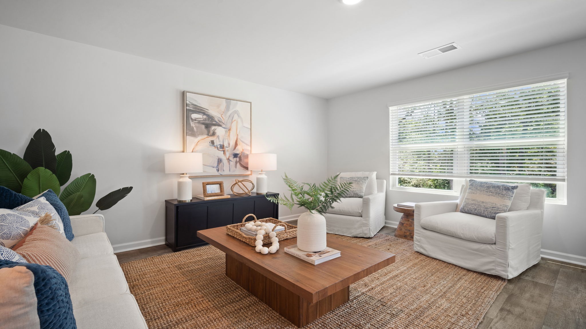 Spacious great room in the Belhaven floor plan with abundant natural light, open living space, and seamless flow to the kitchen.