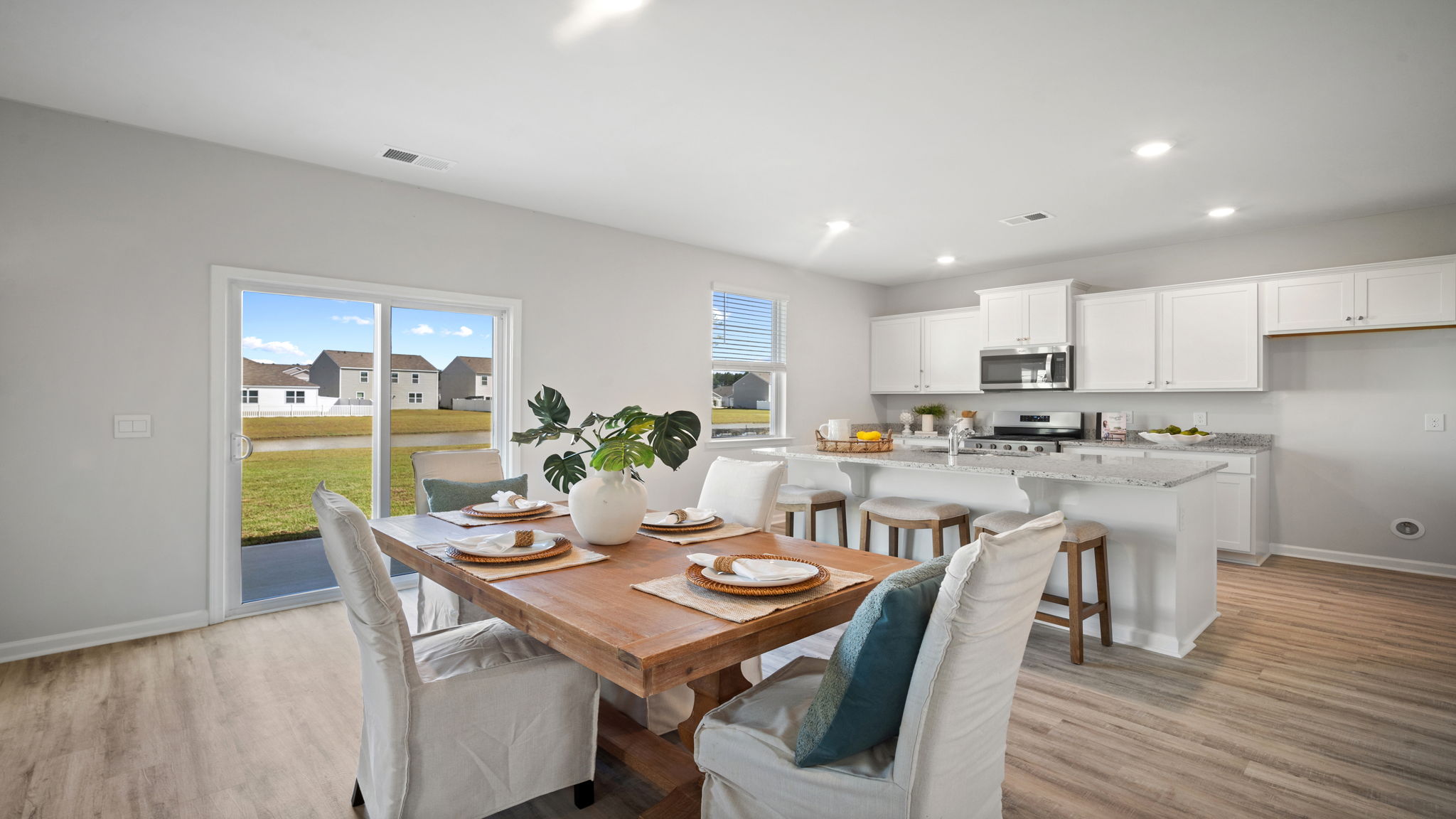 Open dining area conveniently located between the kitchen and family room.