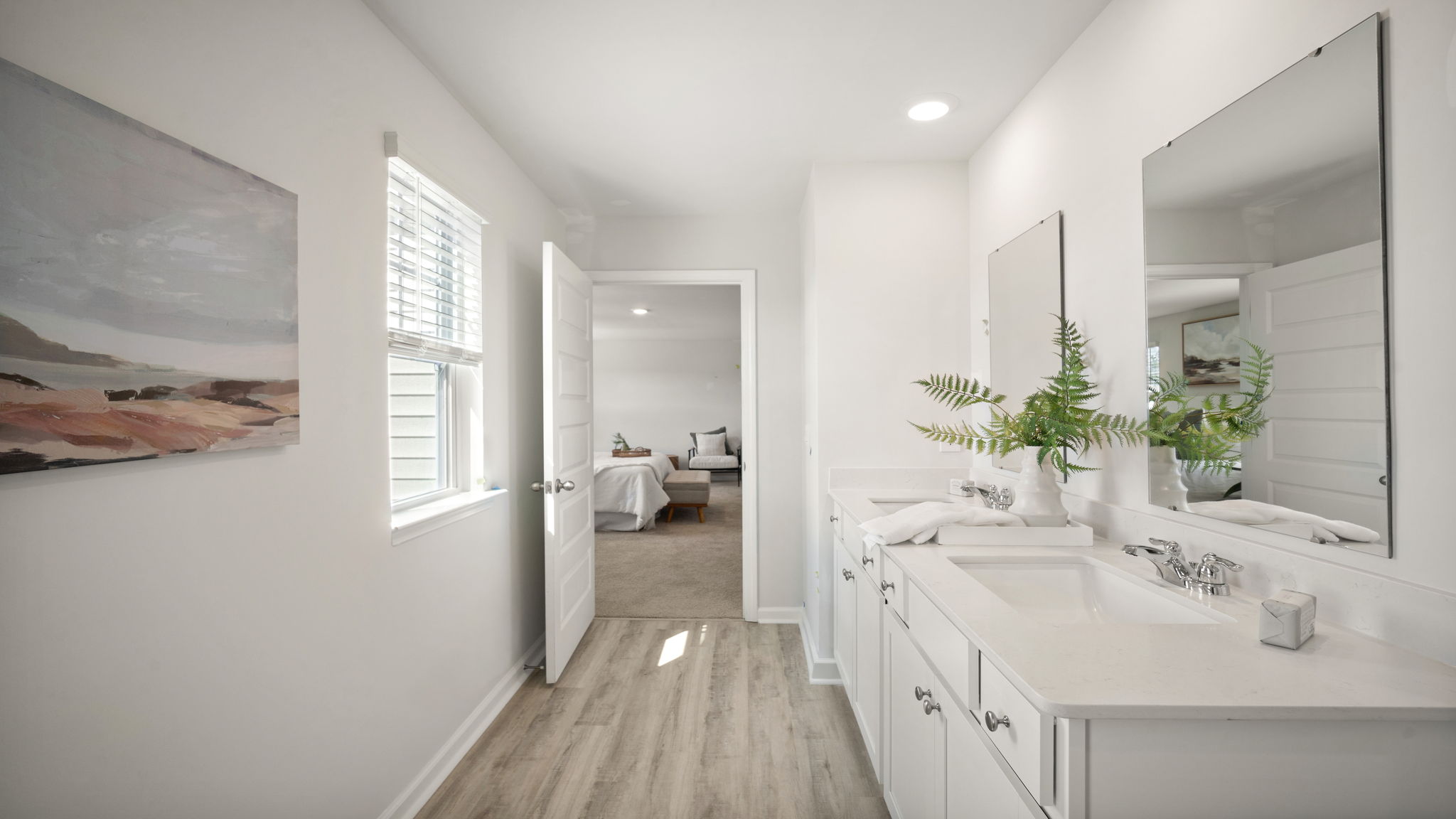 Elegant primary suite bathroom with generous vanity space and contemporary fixtures.