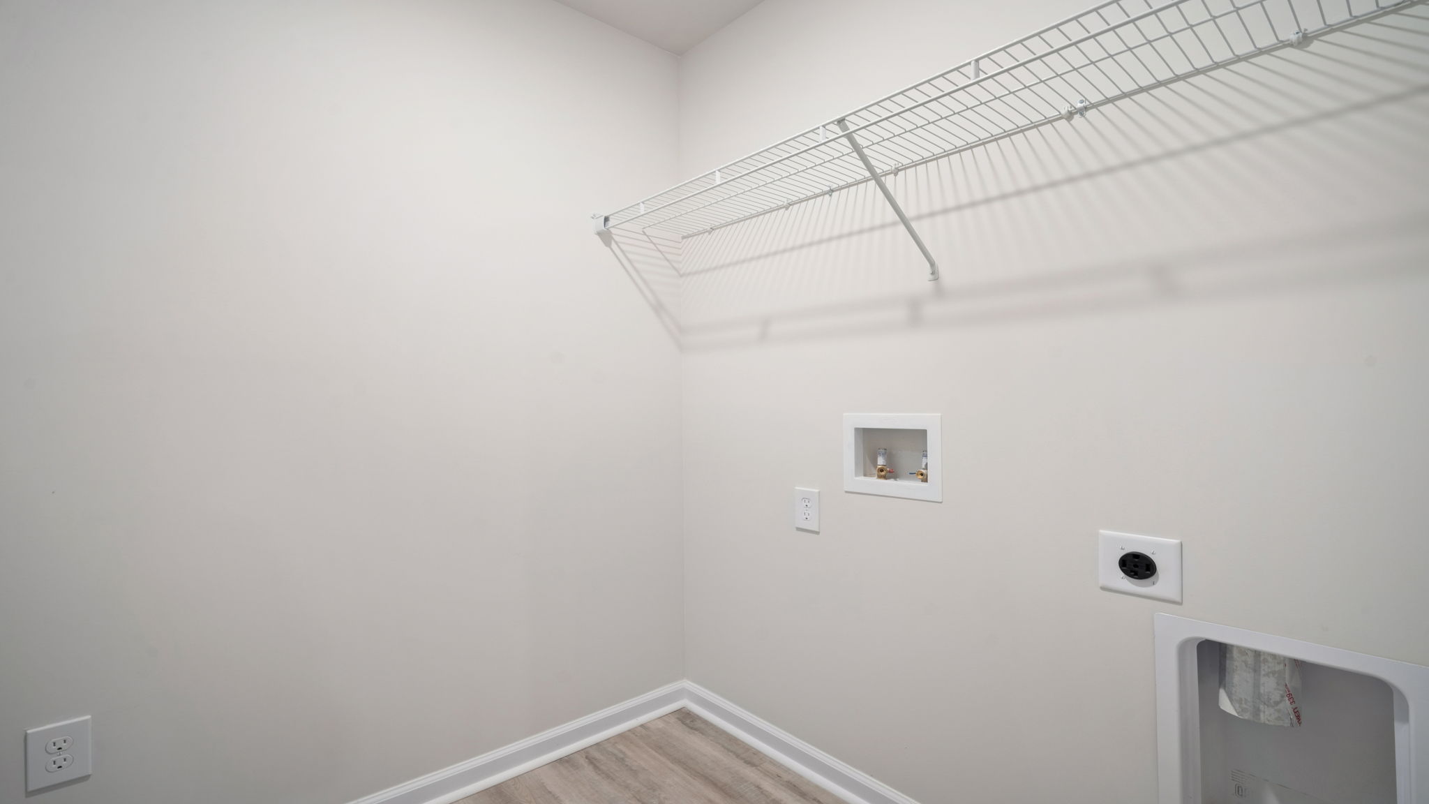 Functional laundry room with dedicated utility and storage space.