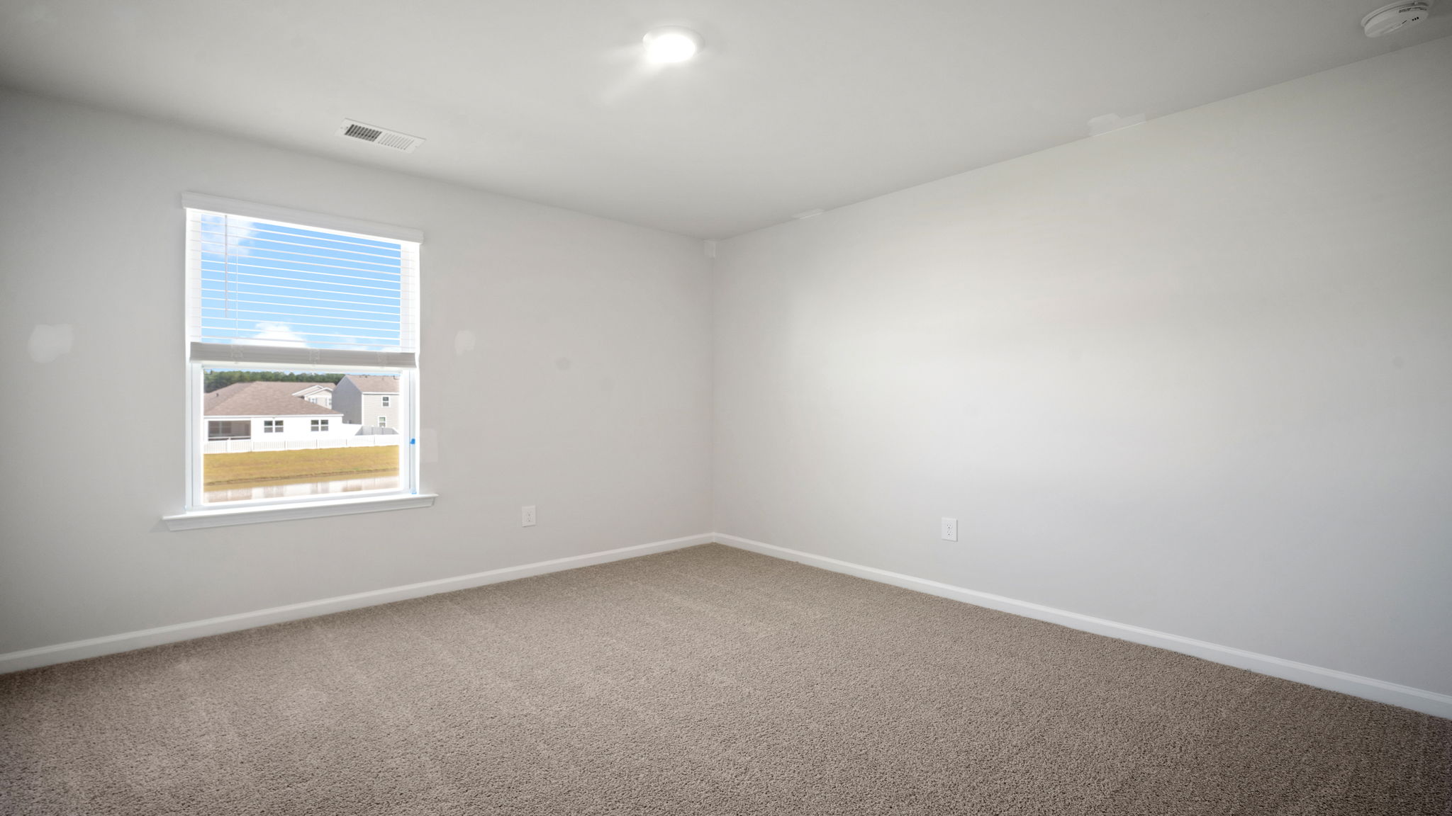 Bright guest bedroom with versatile design and ample closet space.
