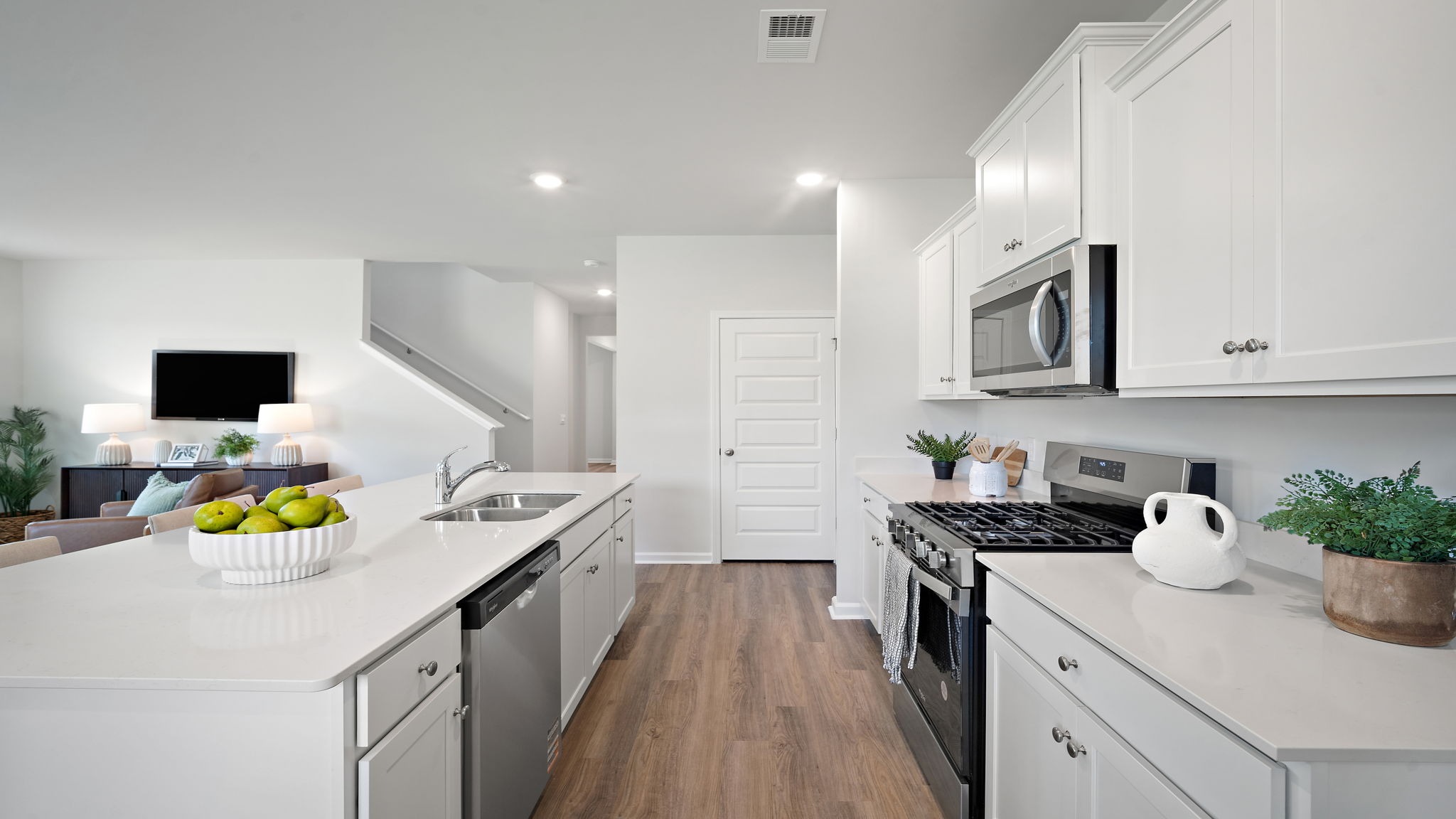 Bright and stylish kitchen offering premium cabinetry, contemporary design, and seamless flow into the dining and living areas.