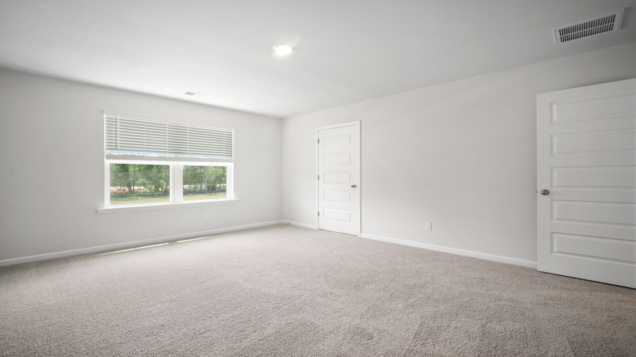 Comfortable guest bedroom in the Salem floor plan featuring natural light, ample closet space, and versatile living options.