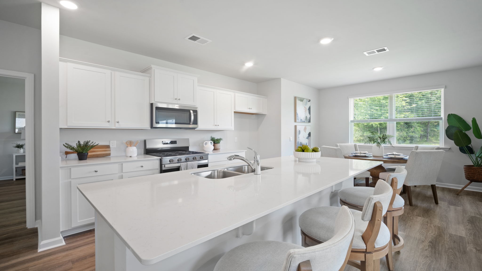 Bright and stylish kitchen offering premium cabinetry, contemporary design, and seamless flow into the dining and living areas.