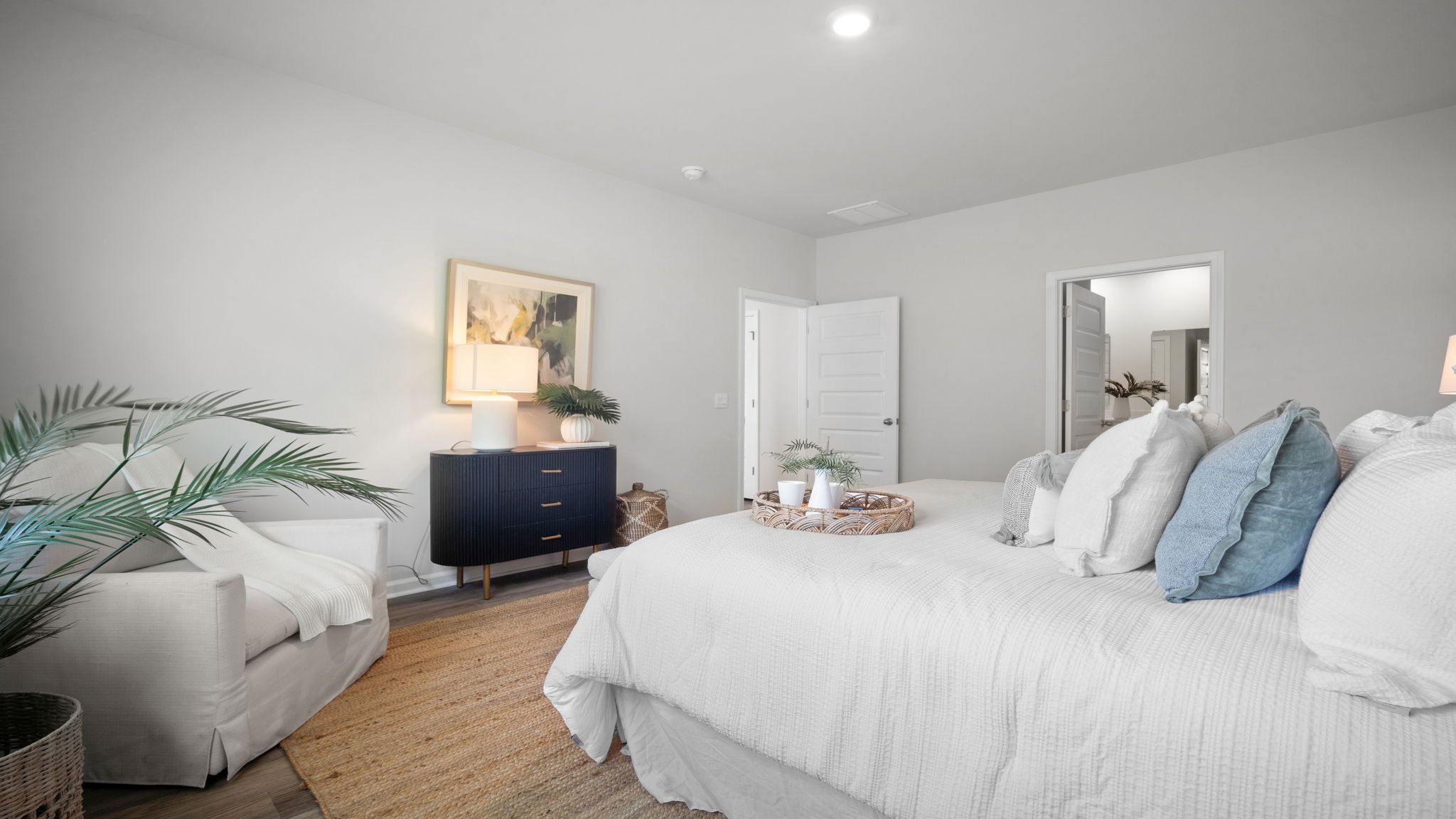 Bright primary bedroom showcasing modern design, abundant natural light, and exceptional comfort.