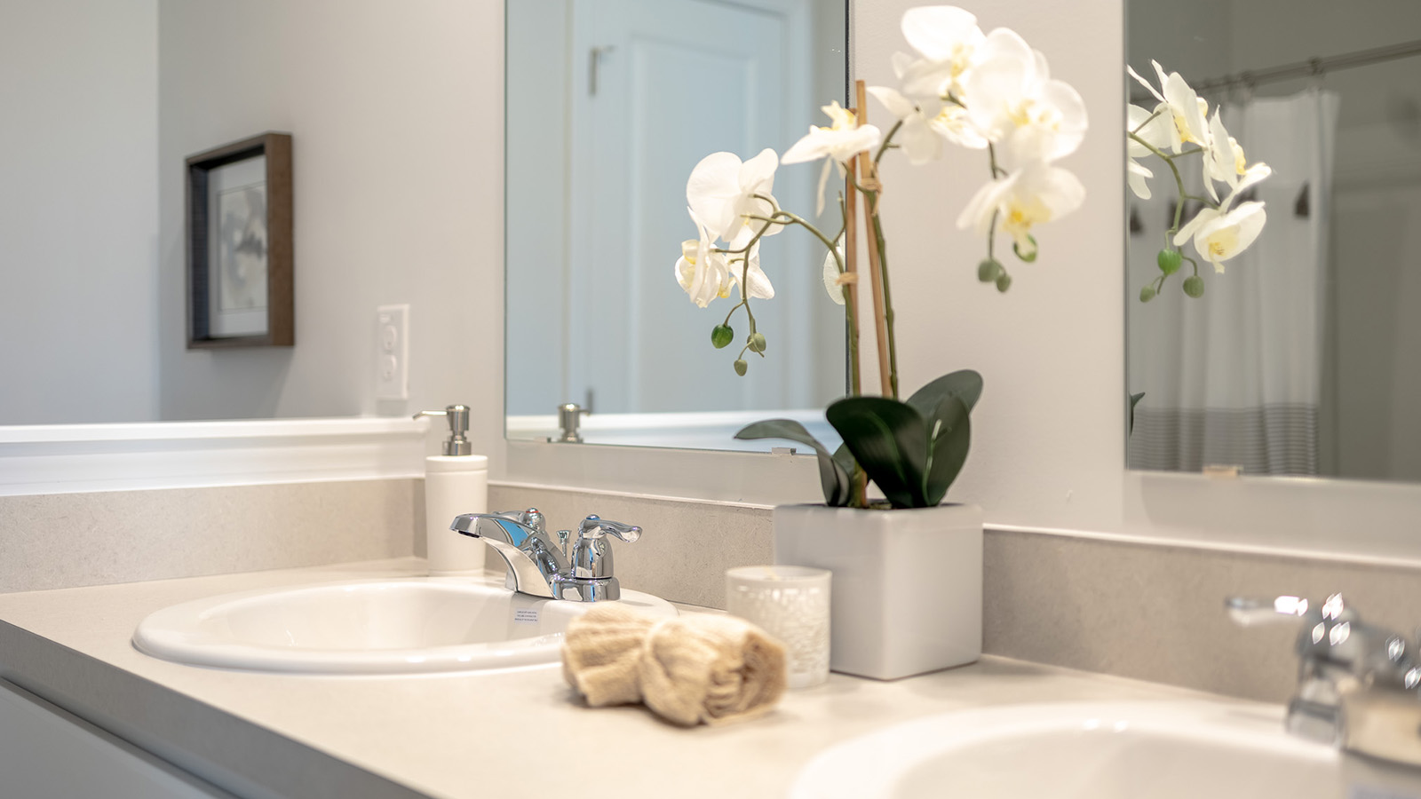 Luxury primary bathroom in the Duncan floorplan featuring dual vanities, modern fixtures, spacious storage, and a walk-in shower designed for everyday convenience and comfort.