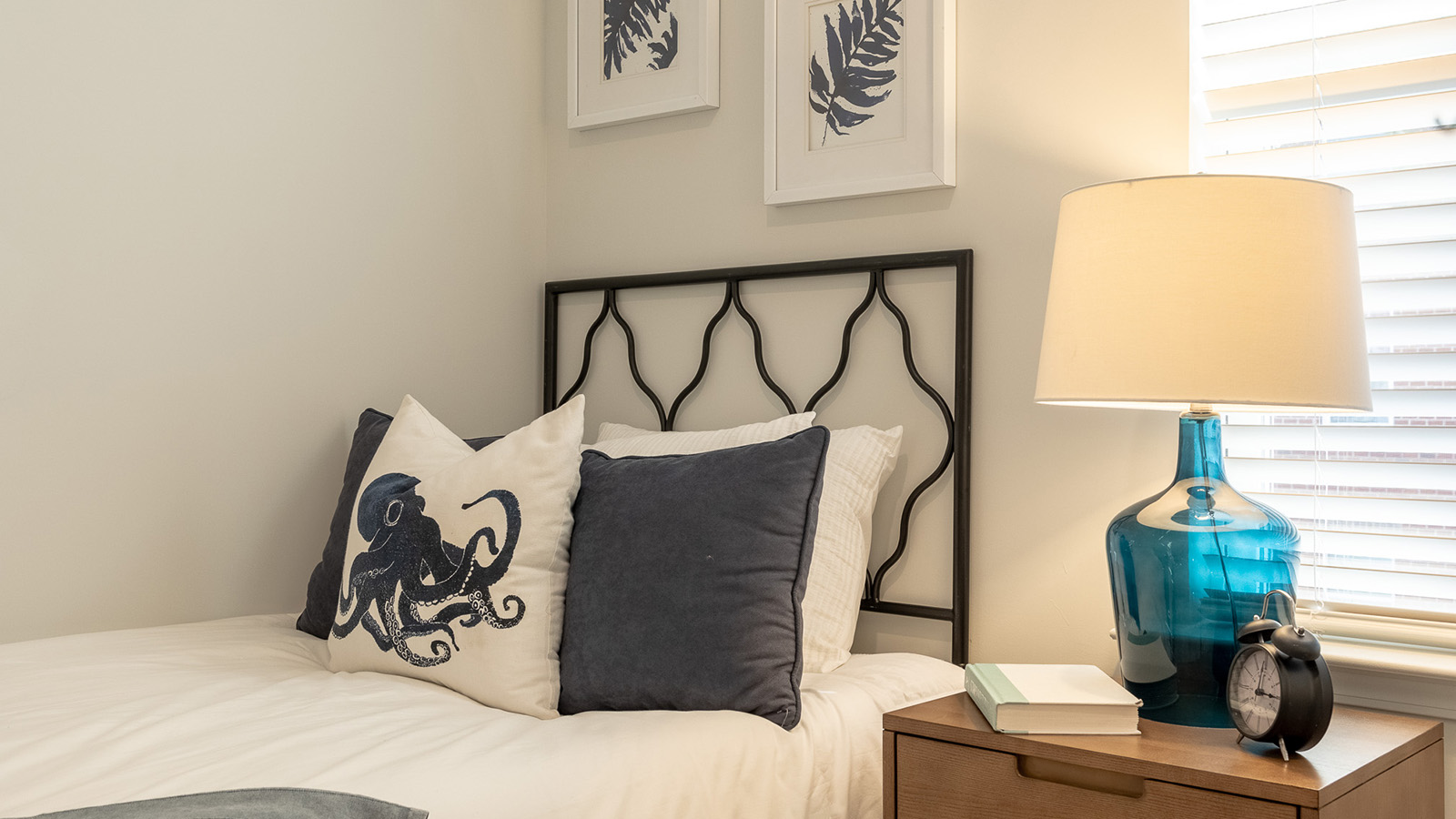 Comfortable secondary bedroom in the Duncan townhome featuring bright windows, modern finishes, and a flexible layout designed to accommodate visitors, growing families, and everyday living needs.