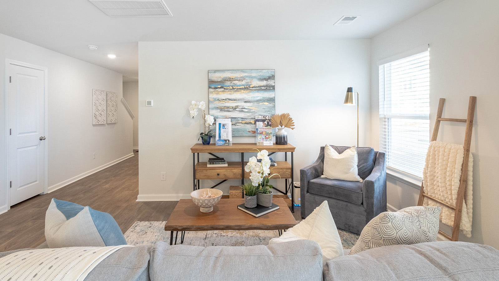 Spacious living room in the Duncan floorplan by D.R. Horton at The Towns at Blue Jay featuring abundant natural light, open-concept design, and seamless connectivity to the kitchen and dining spaces.