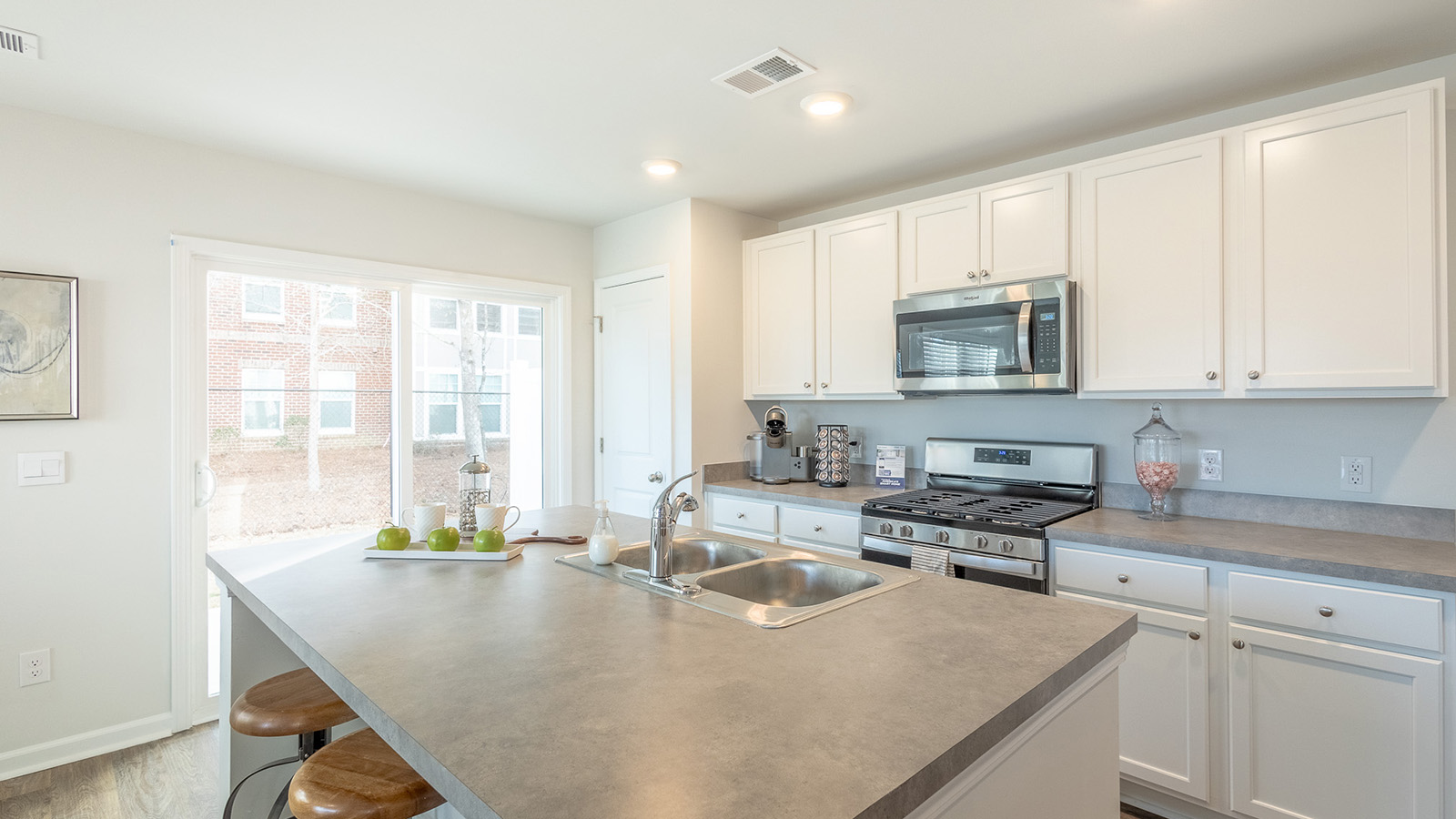 Stylish kitchen in the Duncan by D.R. Horton featuring a large island with seating, durable countertops, energy-efficient appliances, and a functional design ideal for family gatherings and meal preparation.