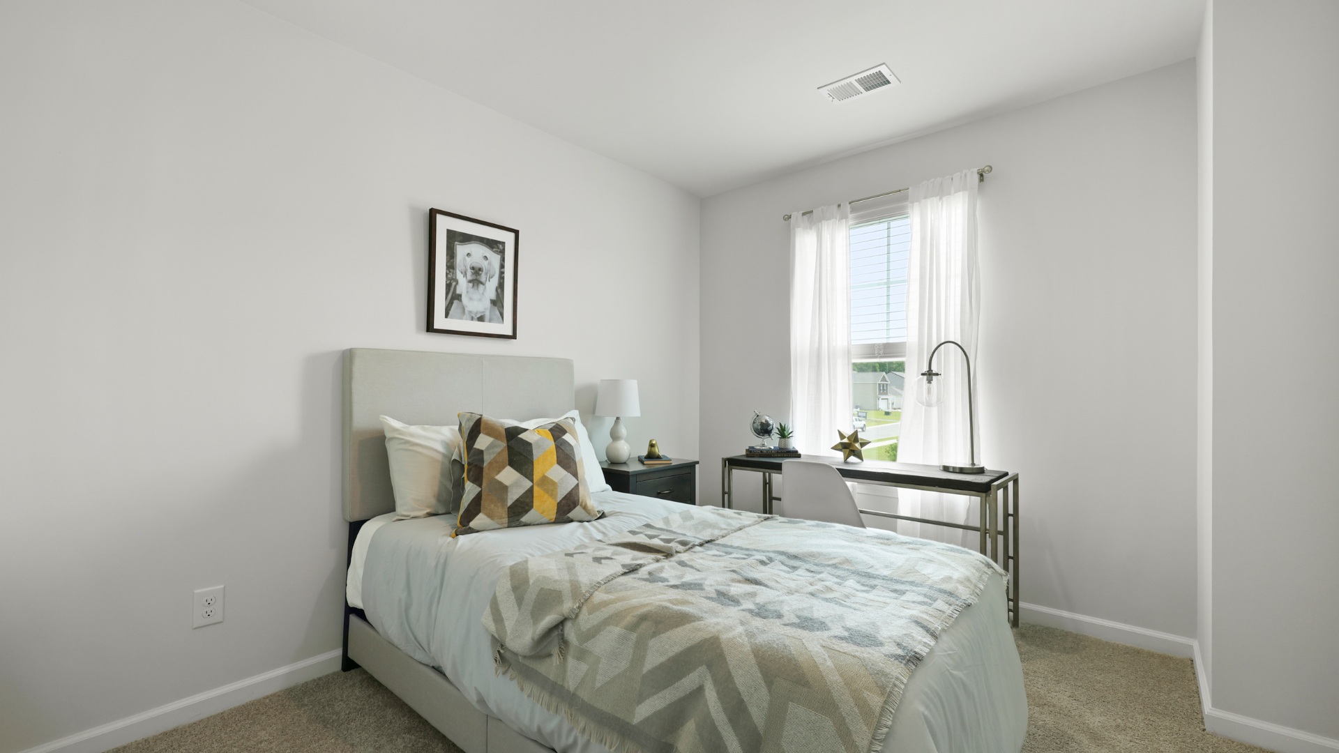 Guest bedroom in the Dillon townhome at The Towns at Blue Jay offering a bright interior, spacious layout, and flexible use as a bedroom, office, or hobby space.
