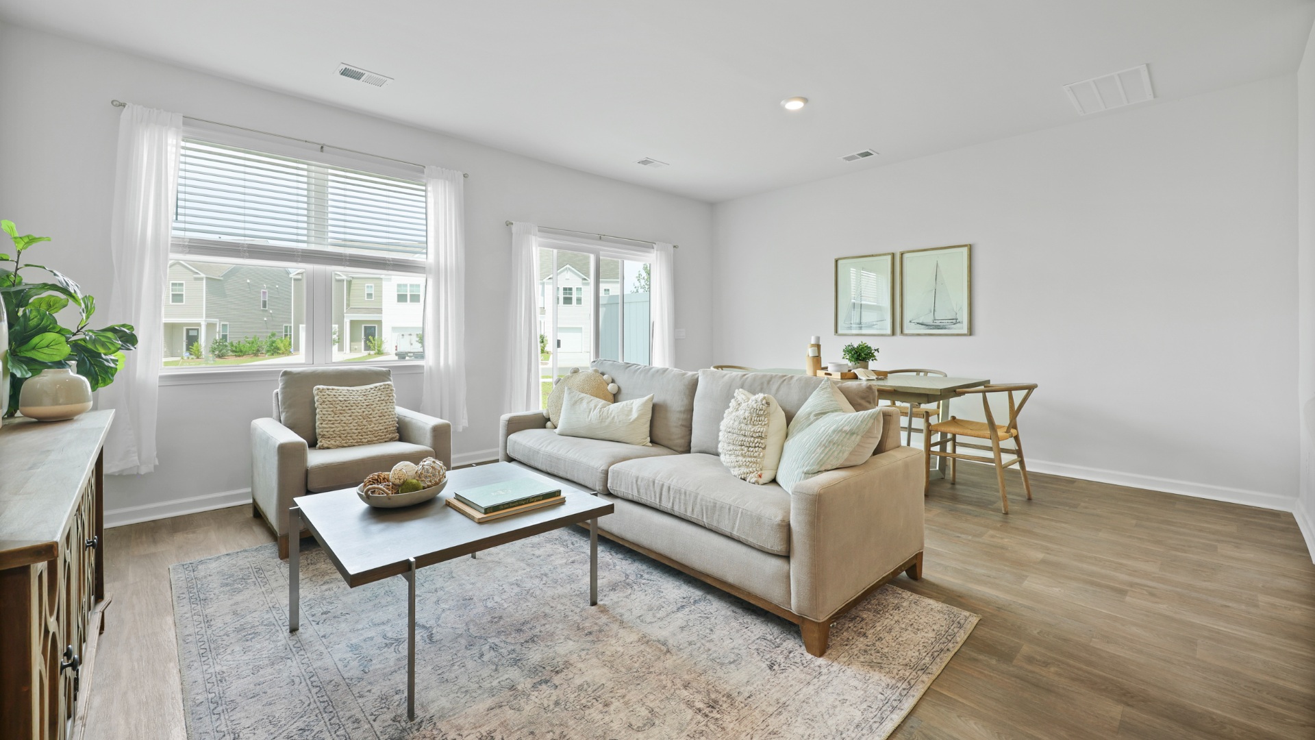 Spacious living room in the Dillon floorplan by D.R. Horton featuring an open-concept design, abundant natural light, and a comfortable gathering space connected to the kitchen and dining area.