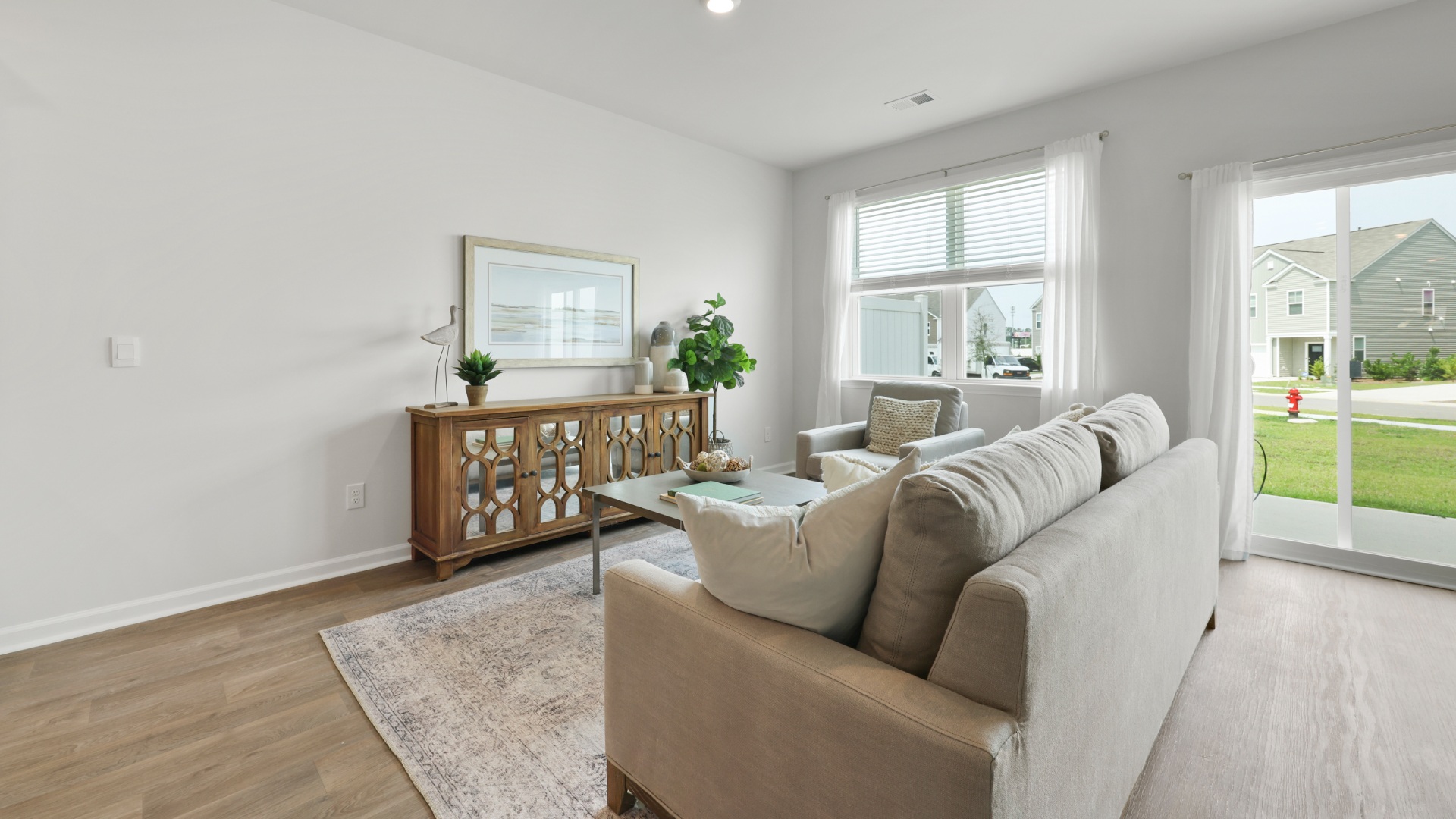 Open family room in the Dillon by D.R. Horton showcasing a seamless flow, large windows, and versatile space designed for everyday comfort and connection.