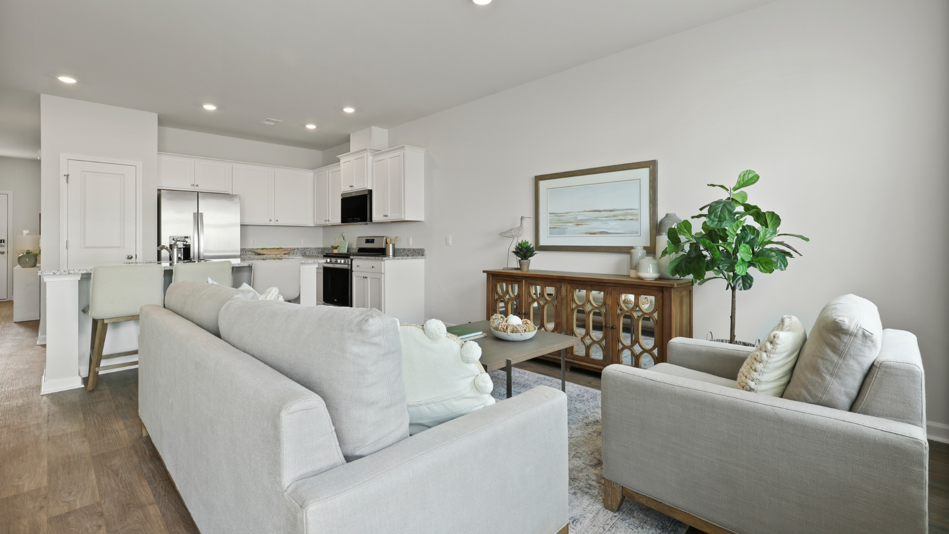 Open-concept living room in the Dillon floorplan by D.R. Horton at The Towns at Blue Jay featuring abundant natural light, spacious seating area, modern finishes, and seamless flow to the kitchen and dining spaces, creating an inviting atmosphere for everyday living and entertaining.
