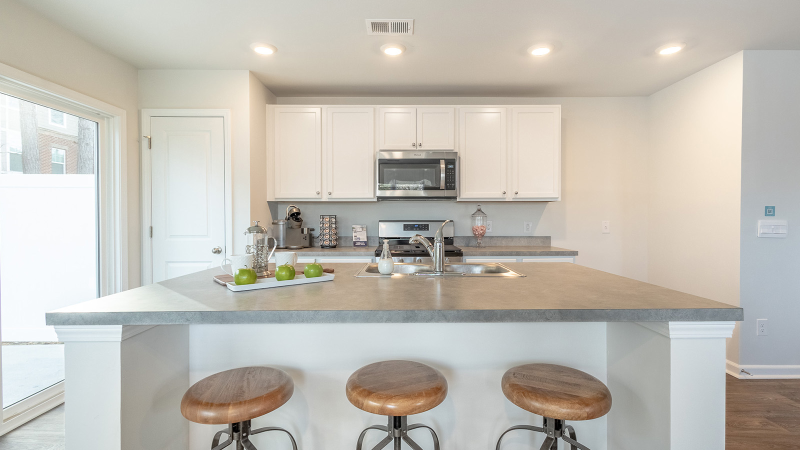 Gourmet kitchen in the Dillon floorplan by D.R. Horton at The Towns at Blue Jay featuring a large center island, modern cabinetry, stainless steel appliances, and open-concept design perfect for entertaining.