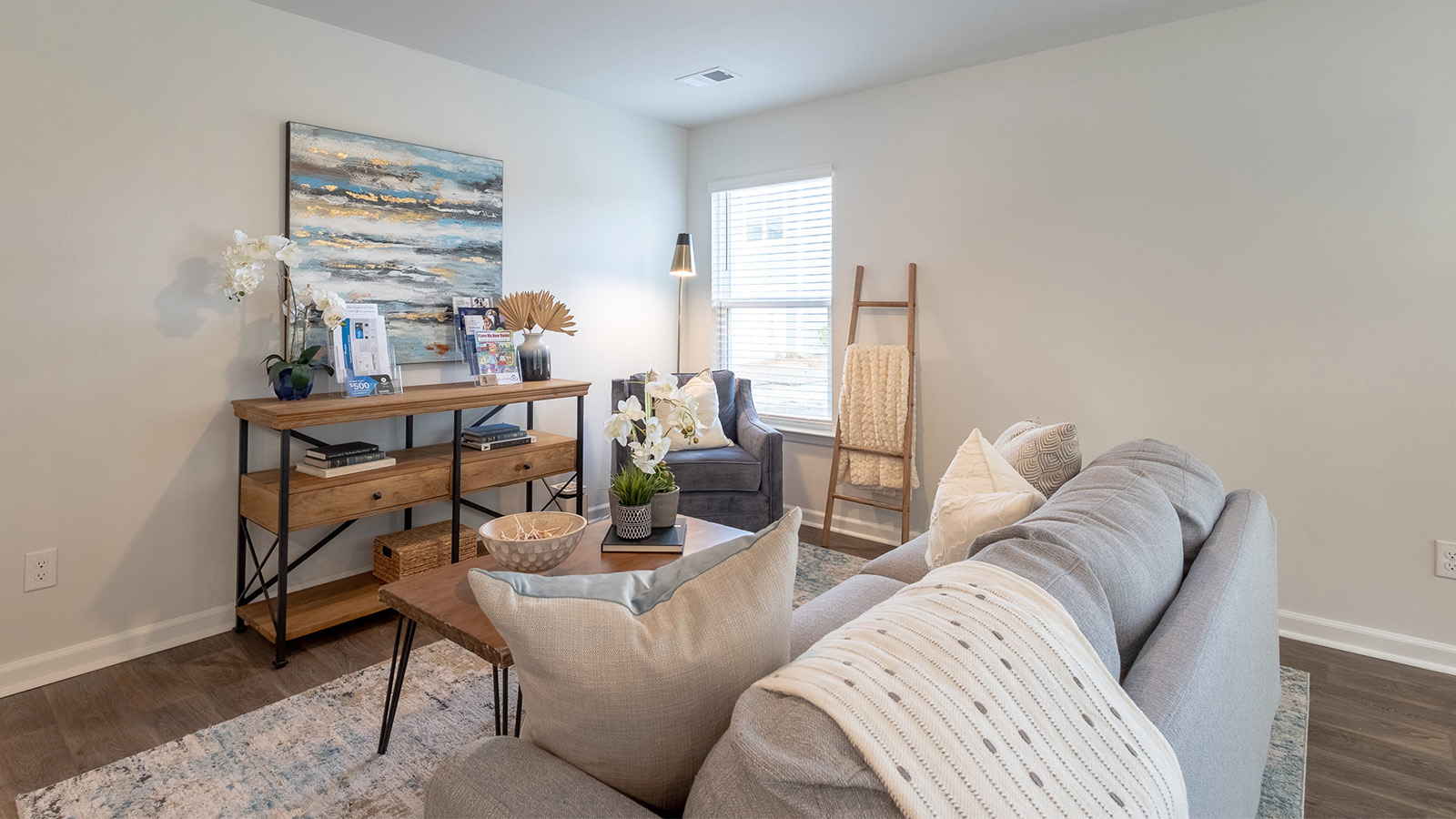 Open-concept living room in the Dillon floorplan by D.R. Horton at The Towns at Blue Jay featuring abundant natural light, modern finishes, spacious seating area, and seamless flow to the kitchen and dining space, ideal for entertaining and everyday living.