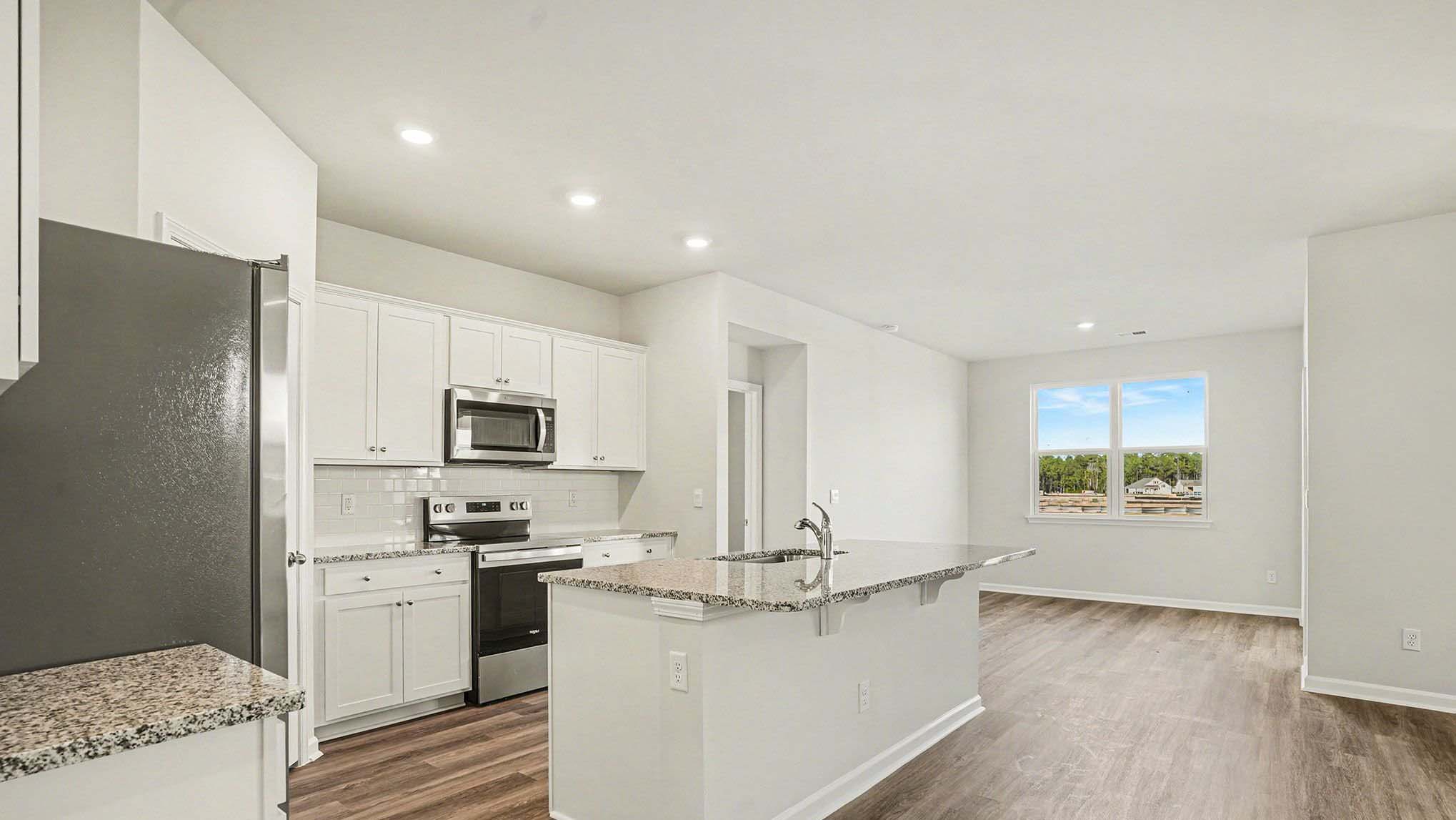 kitchen with granite and ample lighting