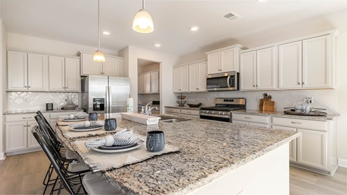 kitchen with cream cabinets and granite countertops