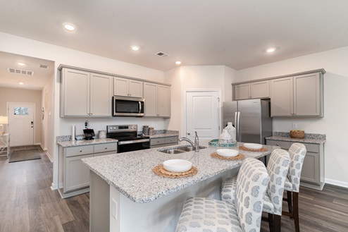 Kitchen with gray cabinets and granite countertops