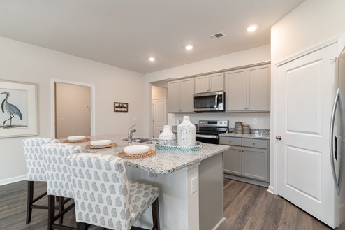 Kitchen with gray cabinets and granite countertops