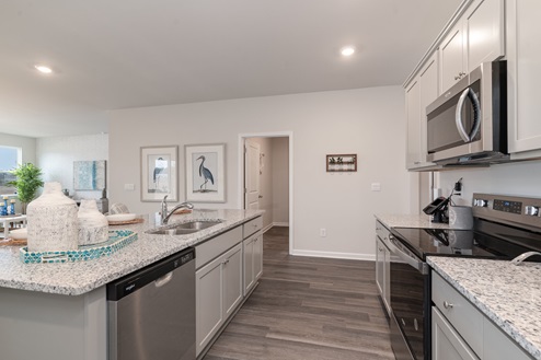Kitchen with gray cabinets and granite countertops