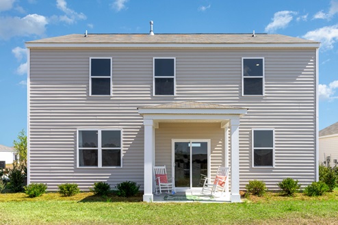 Galen exterior with vinyl siding and black shutters back of house