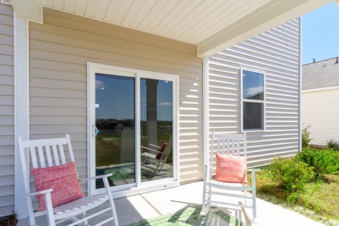Galen exterior with vinyl siding and patio