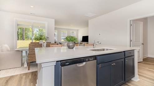 Kitchen overlooking dining area with blue cabinets