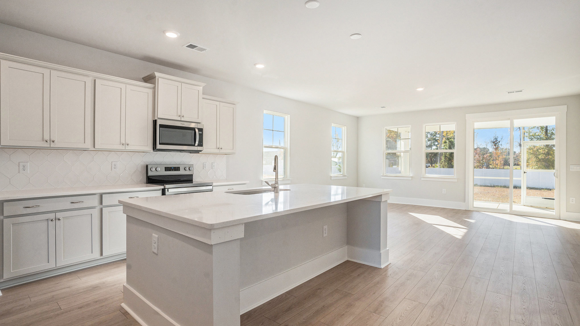 kitchen with gray cabinets and quarts countertops with craftsman style trim