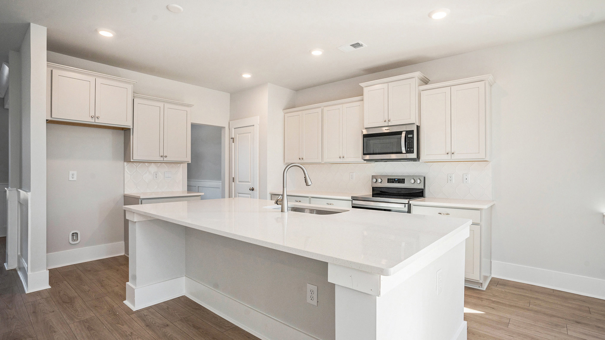 kitchen with gray cabinets and quarts countertops with craftsman style trim