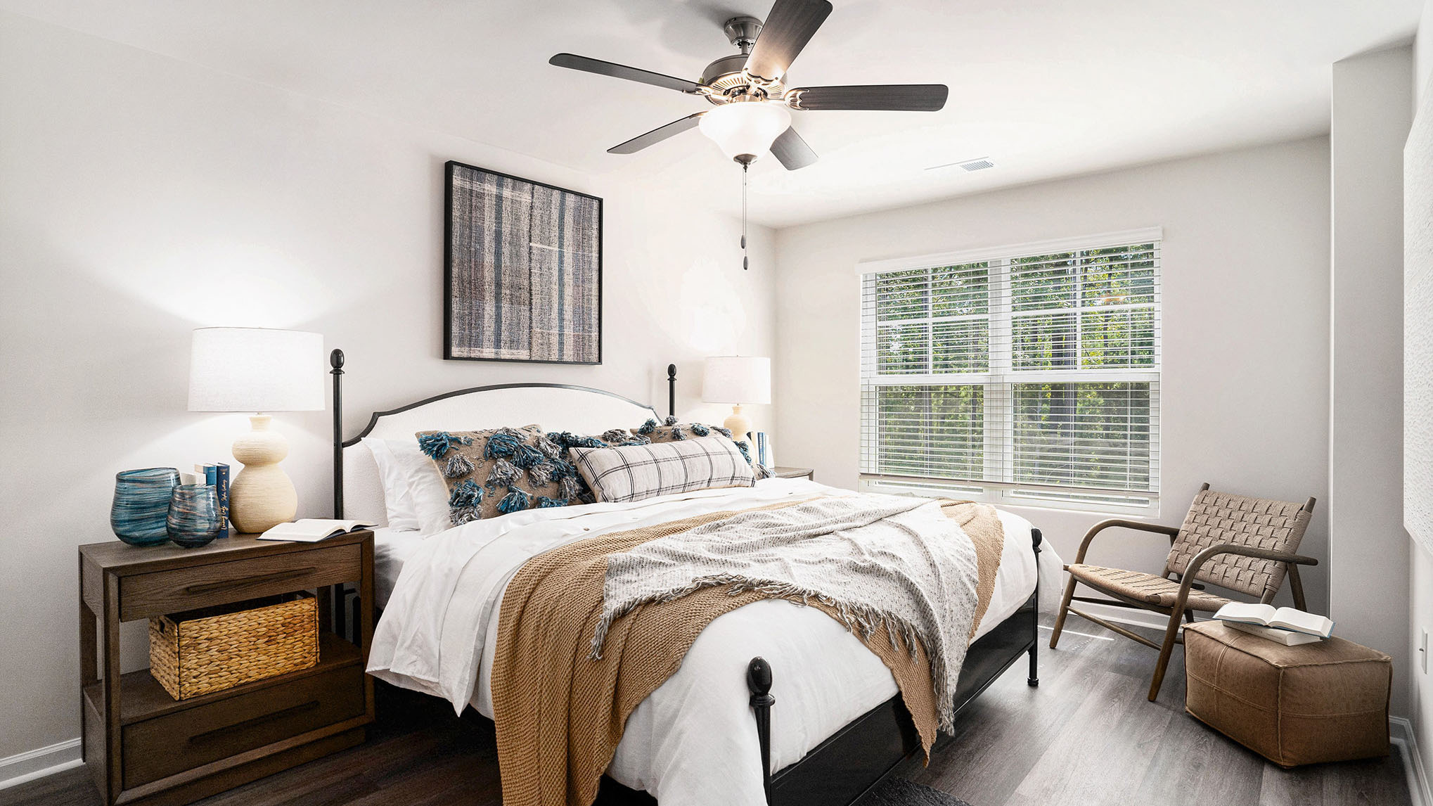 primary bedroom with double window and ceiling fan