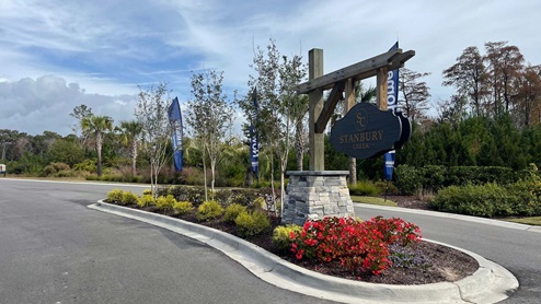 Stanbury Creek entrance monument with flags