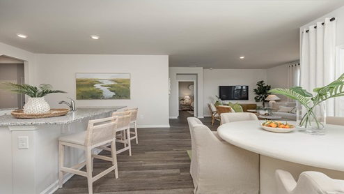 Cali kitchen with bar stools and living room
