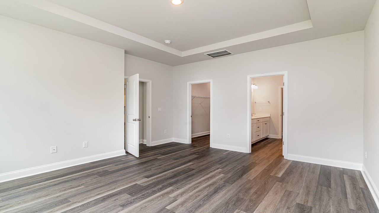 primary bedroom with tray ceilings
