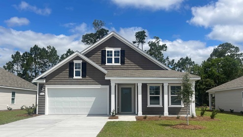 Two-story home with two-car garage and front patio