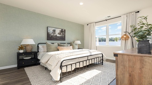 Spacious bedroom one with wall paper