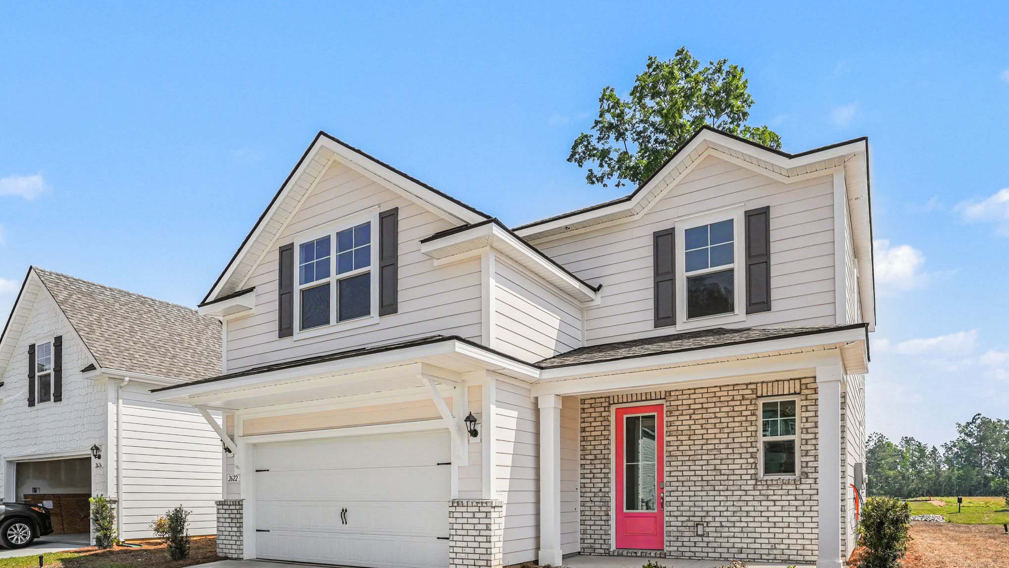 two story home with pink door