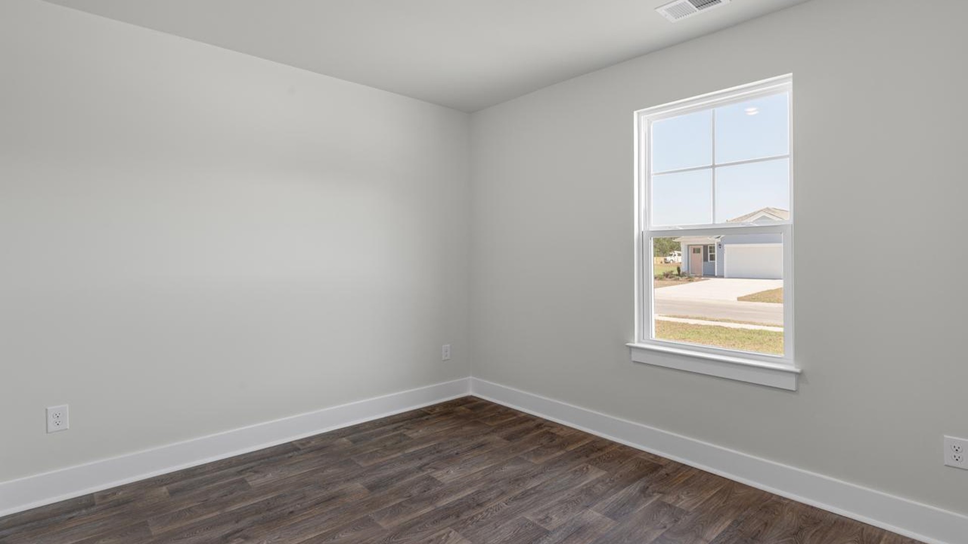 At the front are two guest bedrooms and a full bathroom, perfect for visitors or a home office. The open-concept family room,