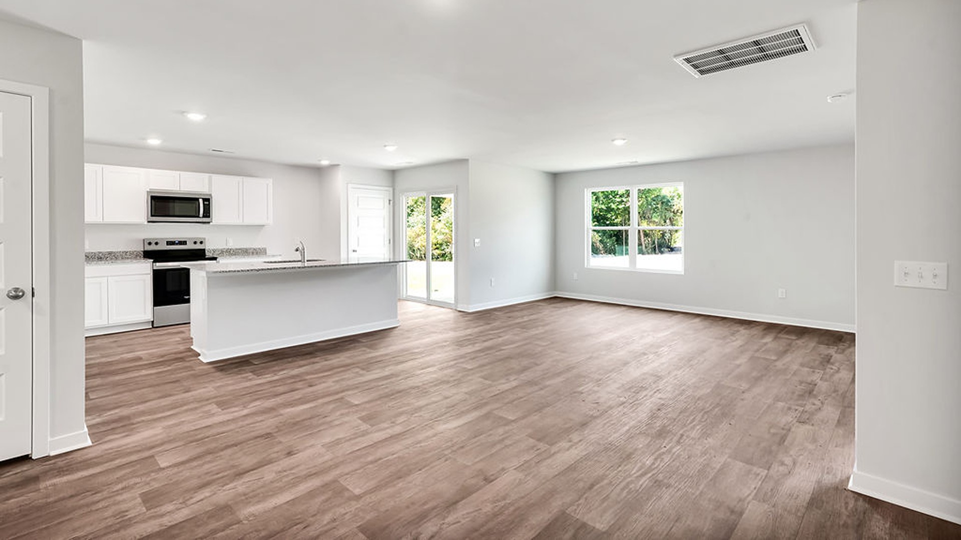 offers a open-concept family room, kitchen, and dining area