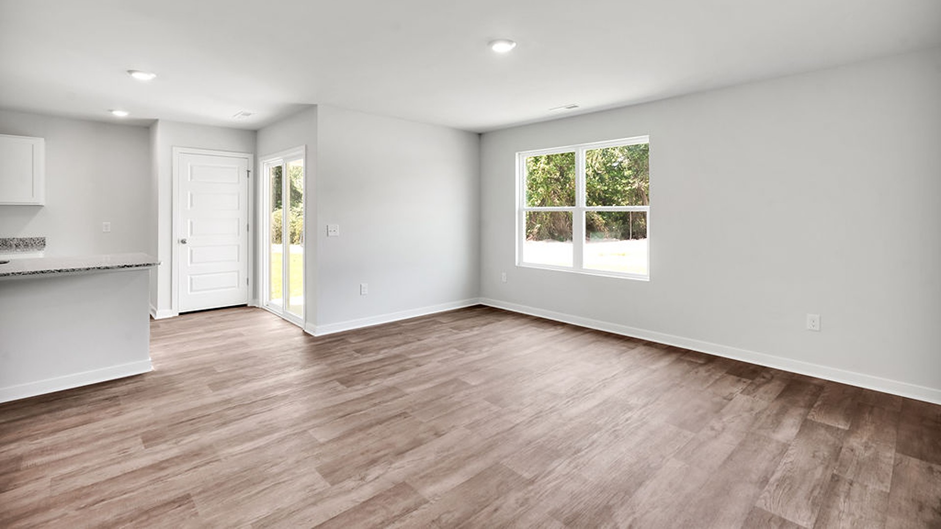 offers a open-concept family room, kitchen, and dining area