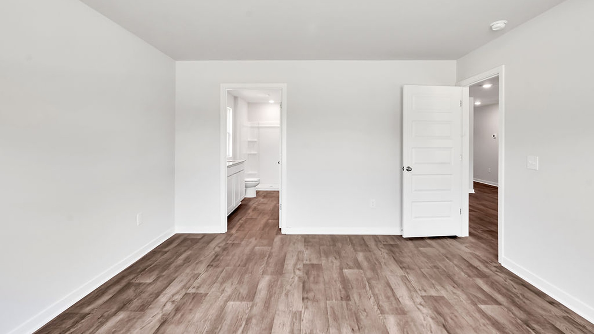 the Primary Suite provides privacy with a large walk-in closet and walk-in shower.