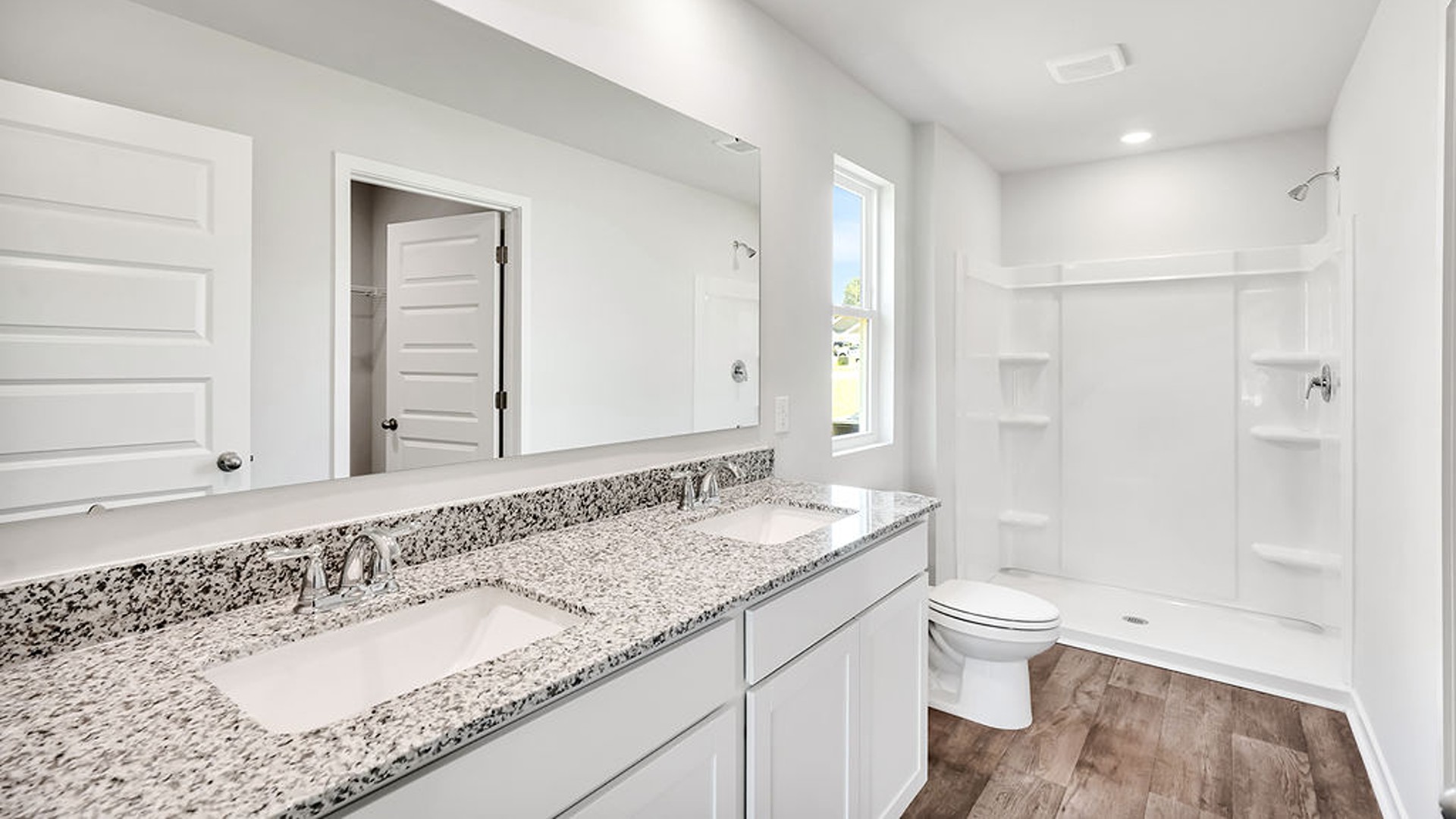 the Primary Suite provides privacy with a large walk-in closet and walk-in shower.