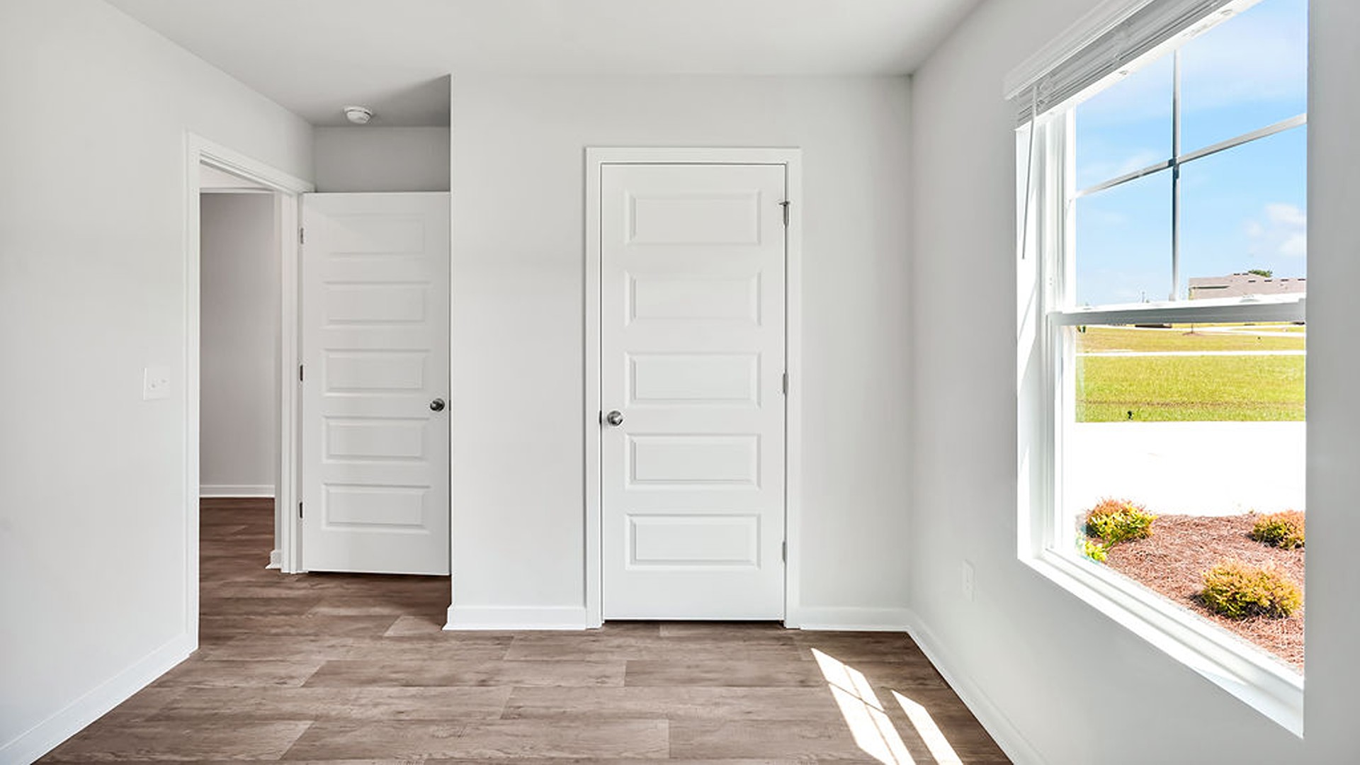 At the front are two guest bedrooms and a full bathroom, perfect for visitors or a home office.