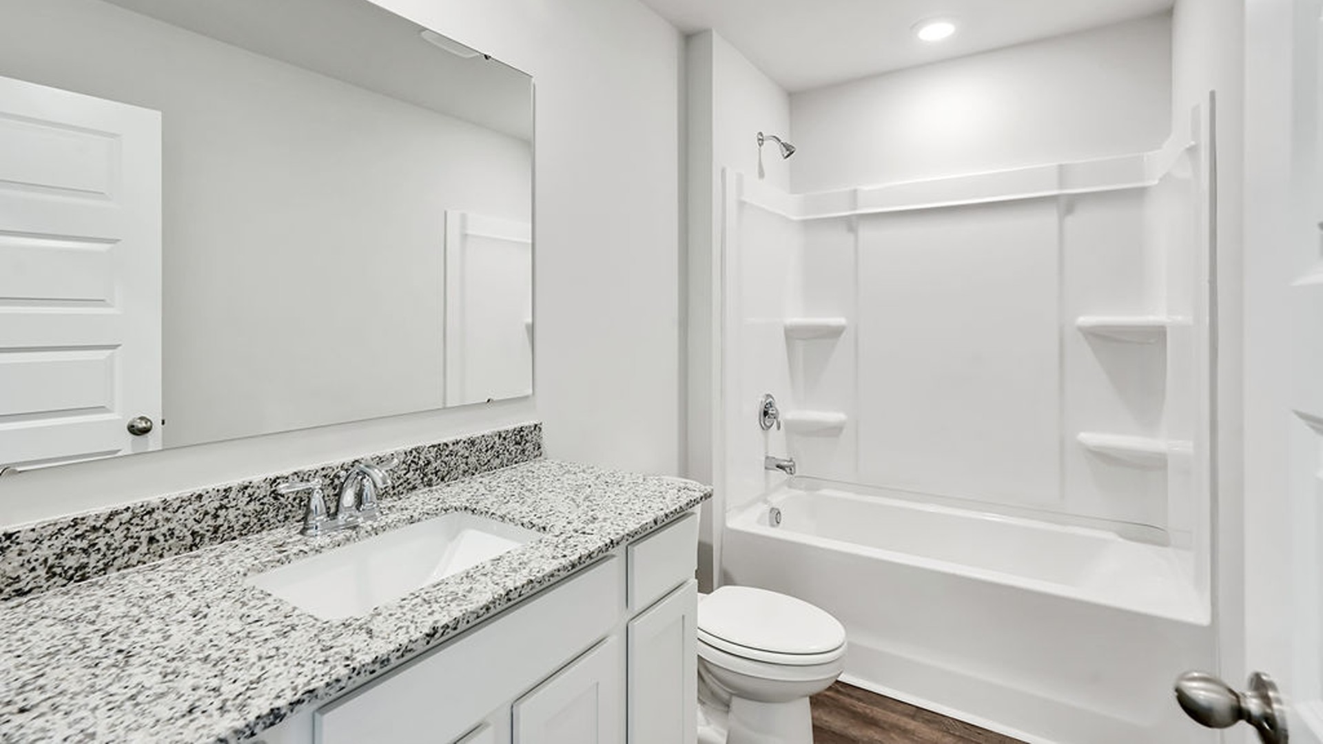 At the front are two guest bedrooms and a full bathroom, perfect for visitors or a home office.