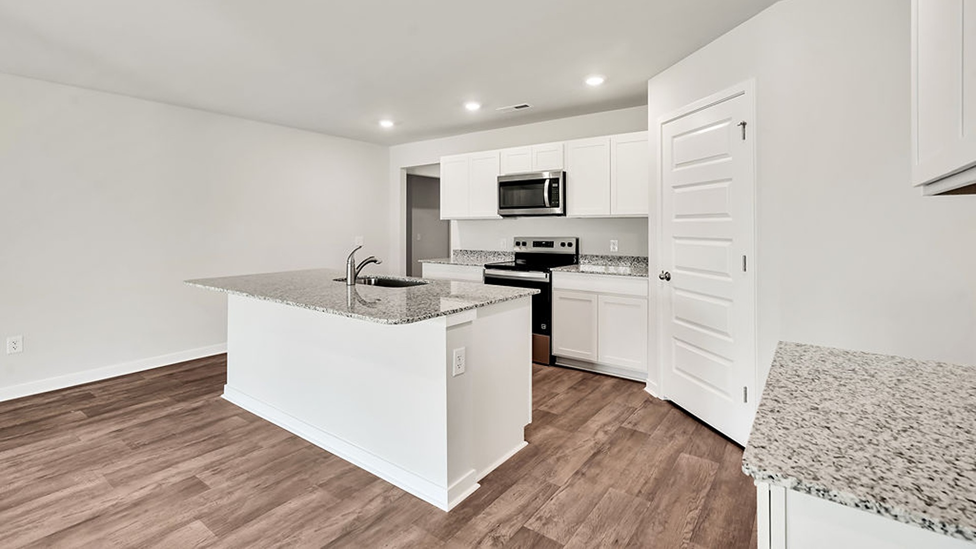The kitchen features beautiful cabinets, granite countertops, and stainless-steel appliances, which are sure to both turn heads and make meal prep easy. You’ll never be too far from the action with the living and dining area right there.