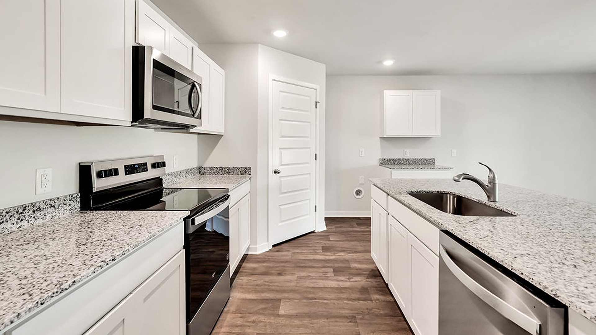 The kitchen features beautiful cabinets, granite countertops, and stainless-steel appliances
