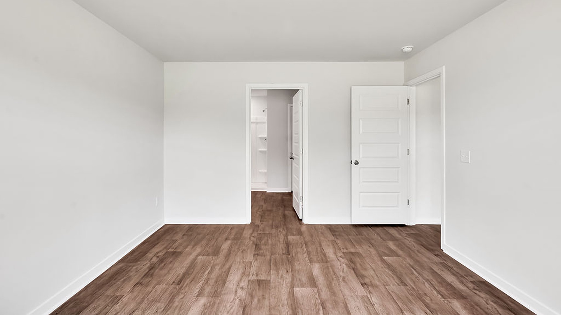 The primary bedroom has its own attached bathroom that features a walk-in closet