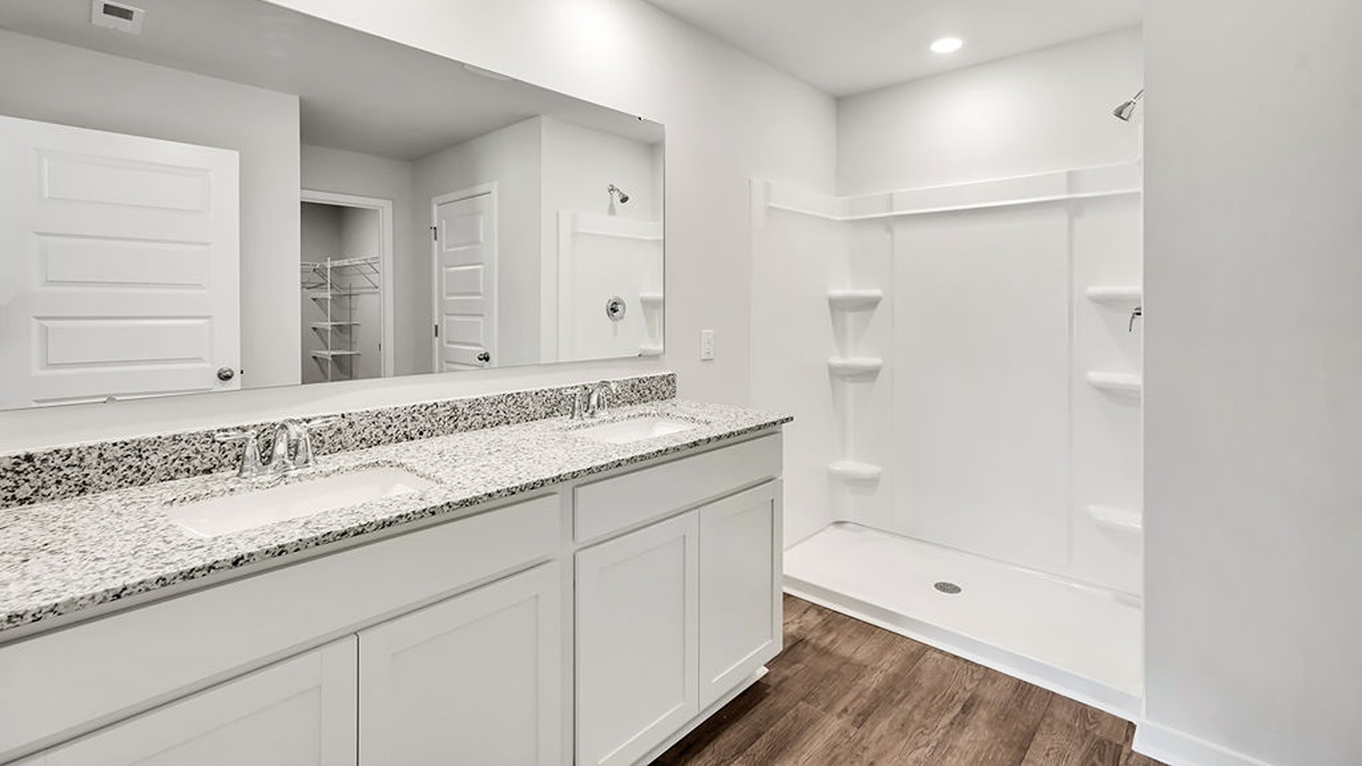 The primary bedroom has its own attached bathroom that features a walk-in closet