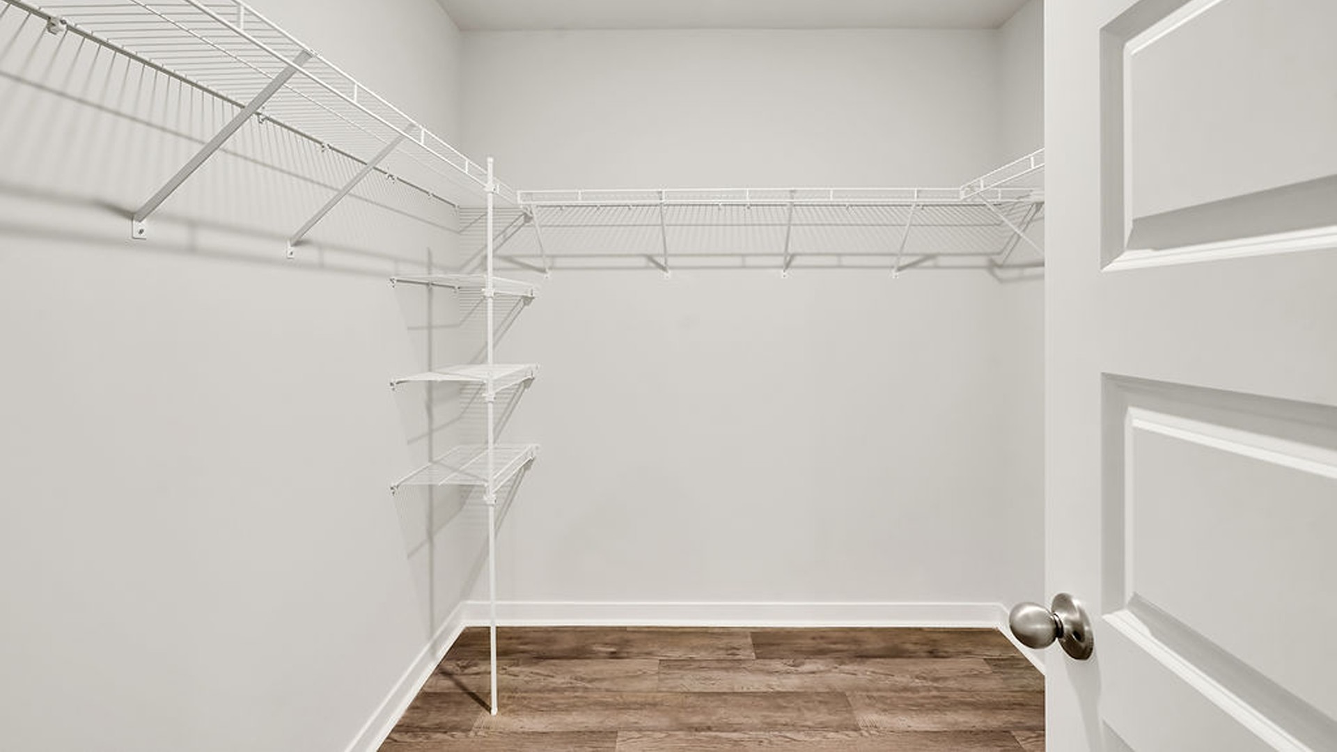 The primary bedroom has its own attached bathroom that features a walk-in closet