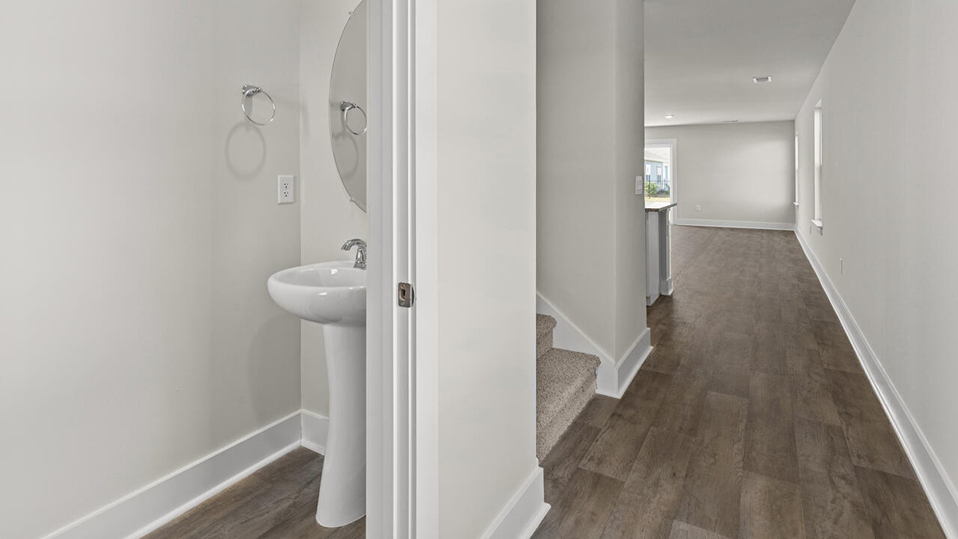 Entering the great room, we find the dining area, family room and a wonderful cook's kitchen are all together for open living. Downstairs, there is a half bath.