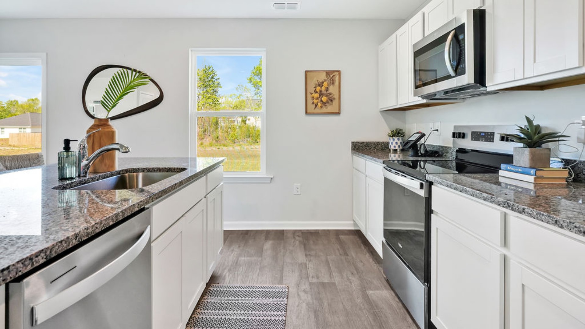 The kitchen features a large island and stainless-steel appliances,